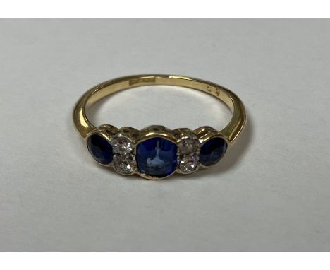 A 9-carat gold mounted dress ring set with three graduated sapphires interspersed by pairs of small diamonds, 2.1 g, size M C