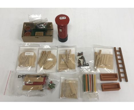 A quantity of various doll's house garden items to include pillar box, letter box front, garden pots, barrow, spade, fork, ho