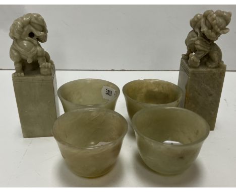 A collection of four Chinese pale green jade tea bowls of inverted bell form raised on circular feet approx. 5.1 cm diameter 