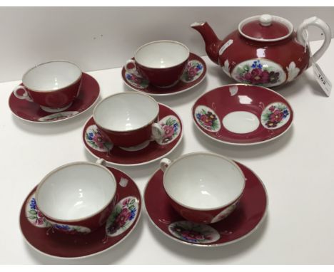 A mid 19th Century Gardner porcelain tea set, puce ground with medallions of floral sprays, bearing oxide red over-glazed mar