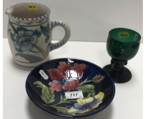 A Walter Moorcroft "Hibiscus" pattern shallow bowl on a circular foot, bearing impressed and signature mark to base, 18.5 cm 