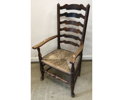 A late 18th Century ash armchair, attributed to the North West Region circa 1780, the wavy ladder back on turned supports, fl