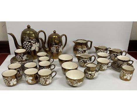 A large collection of Grays Pottery gold luster wares to include plates, part coffee set and part tea set etc
