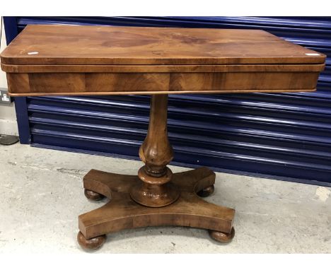 A Victorian mahogany card table, the fold-over top on a baluster turned pedestal to platform quadruped base, 91.5 cm wide x 7