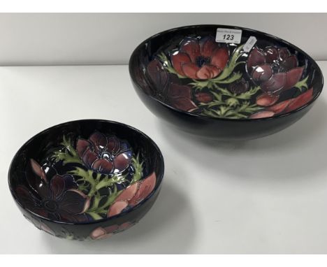 A Moorcroft "Anemone" pattern fruit bowl on a dark blue ground, raised on a circular foot, bearing impressed marks, "WM" mark
