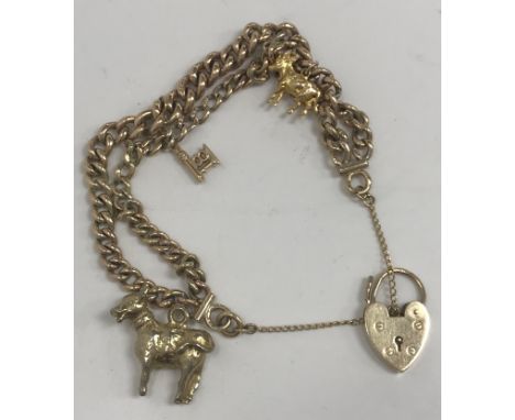 A 9 carat gold double chain charm bracelet with 9 carat gold heart shaped lock, 9 carat gold "18" key, together with two yell