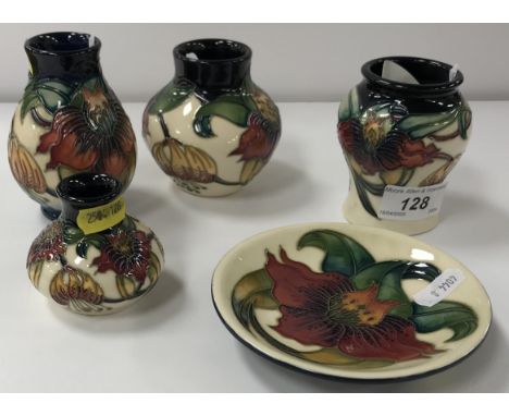 A collection of five small Moorcroft "Anna Lily" pattern pieces including four various baluster shaped vases, tallest 9.5 cm 