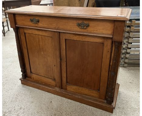 A Victorian mahogany chiffonier base, the top with moulded edge over a single drawer and two cupboard doors flanked by turned