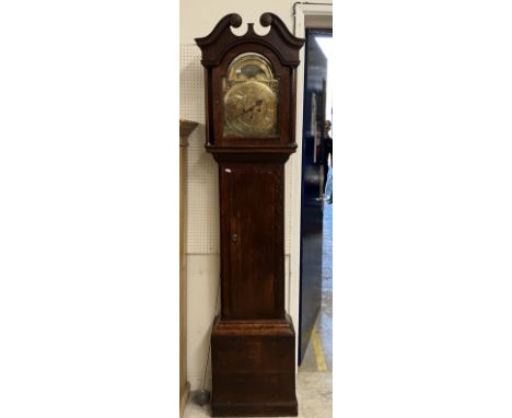 An 18th Century oak cased long case clock, the eight day movement with brass arch dial and sun and moon phase over a chapter 