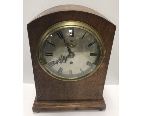 An oak cased dome top mantel clock, the single fusee movement by Elliott Ltd, numbered to back plate 19001-1941, the circular