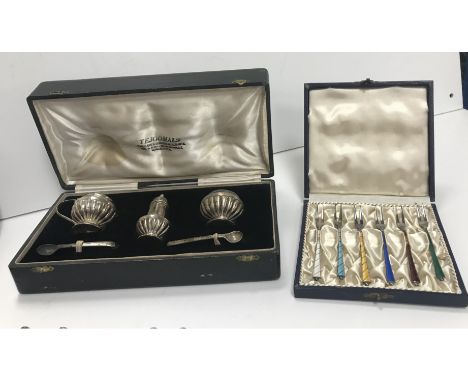 A collection of silver and white metal wares to include a cased set of six silver and enamelled cocktail forks, bearing impor