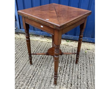 A late Victorian mahogany envelope card table, on turned and ringed legs united by an undertier, 52 cm wide x 52 cm deep x 73