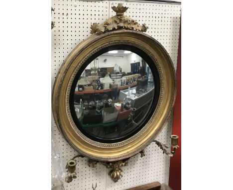 A 19th Century carved giltwood and gesso framed girandole wall mirror, the central convex plate within an ebonised slip and l