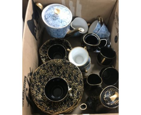 A box containing a Chodziez Vintage China coffee set in black and gold, together with a further Polish part coffee set and a 