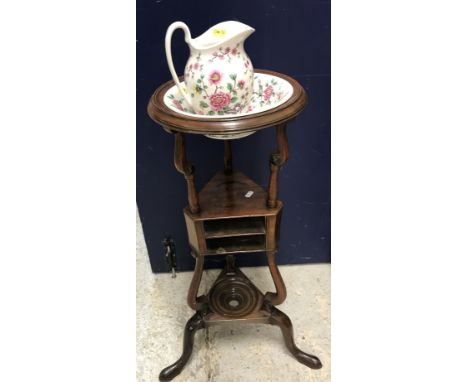 A 19th Century mahogany circular washstand with bowl recess over two small shelves (formerly with drawers) on S scroll suppor