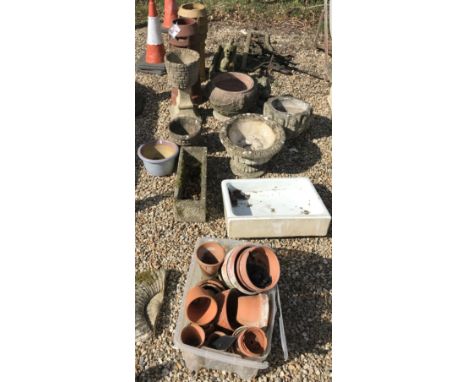 A collection of terracotta garden pots, together with six concrete pots, a Belfast sink and two concrete chimney pots and two