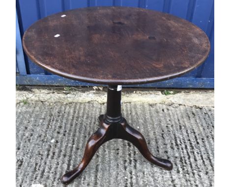A George III mahogany tea table, the circular snap top on a bird cage to turned pedestal and cabriole tripod base, 76 cm diam