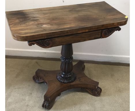 A late Regency rosewood fold-over card table, the top opening to reveal a green baize-lined interior, over a plain frieze wit
