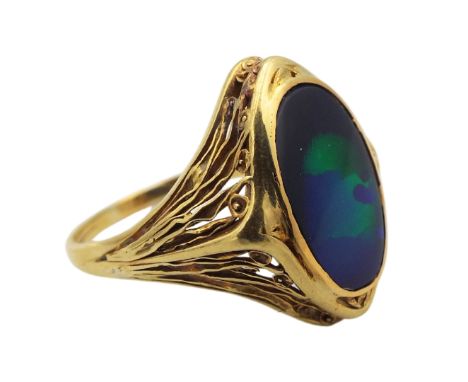 A boulder opal ring with fine worked shoulder decoration of poppies in yellow metal tests above 14K size Q total weight 4.73g