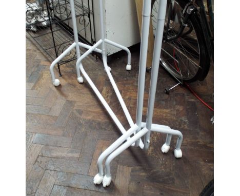 Two light metal clothes rails on wheels