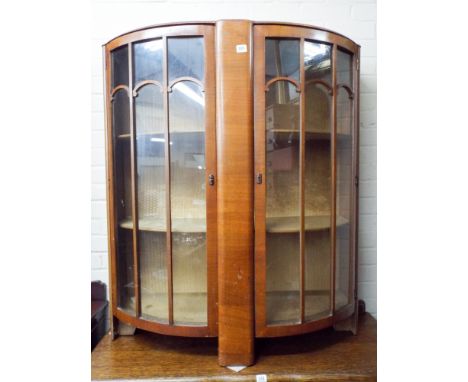 A walnut bow fronted two shelf display cabinet