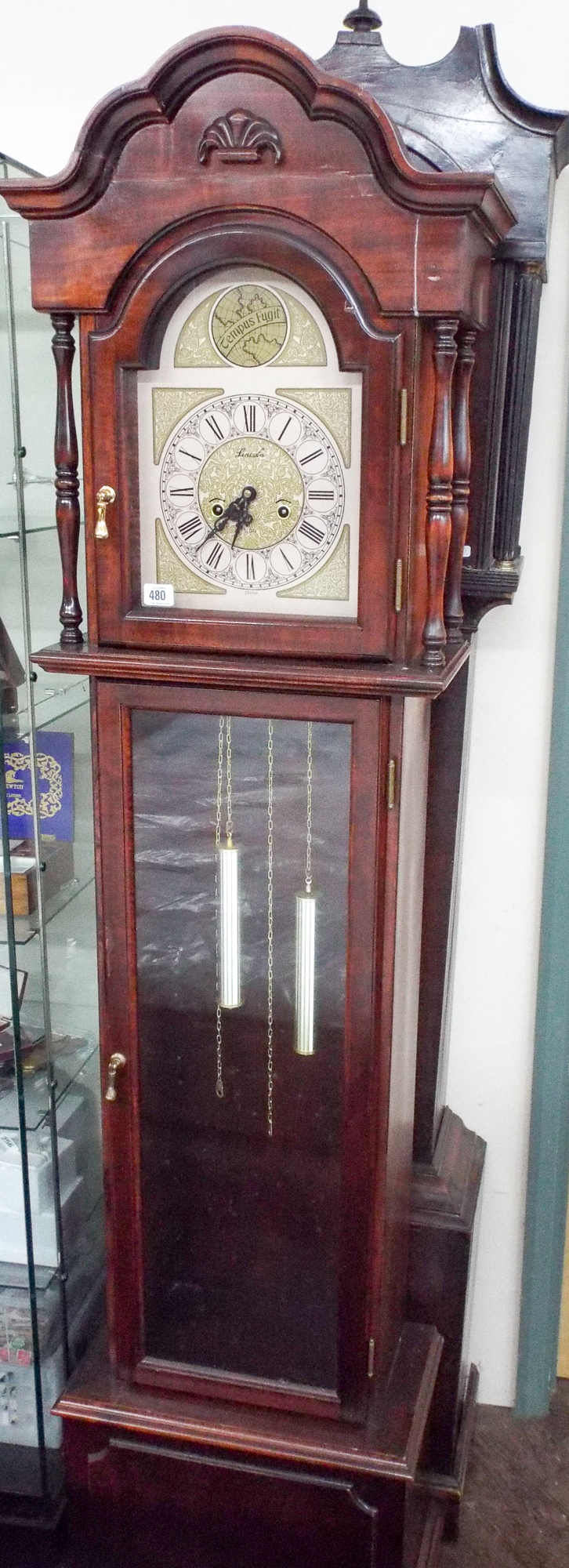 A reproduction Grandfather clock in mahogany case and an old mahogany