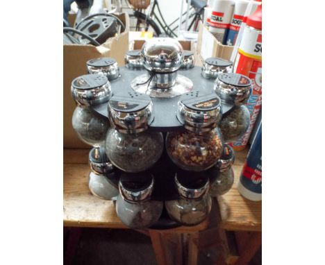 A complete rotating spice rack and a large quantity of cutlery
