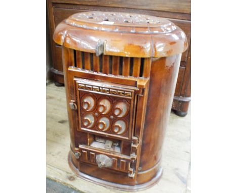 An oval brown enamel solid fuel heating stove