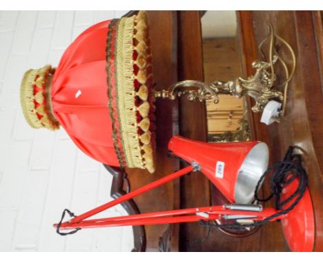 A red angle poise lamp and a brass effect table lamp