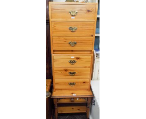 A pair of pine bedside cabinets with brass handles together with a small lamp table and drawer