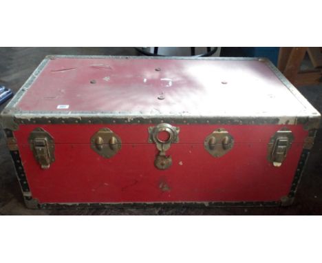 A large red cabin trunk