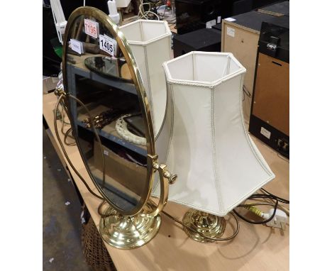 Pair of brass lamps with cream shades, H: 45 cm with shade and a further oval brass free standing mirror, D: 30 cm. Not avail