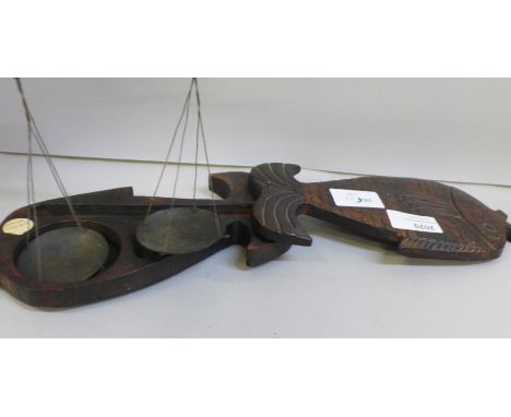 A set of opium scales in a carved wooden case in the form of a fish, 20cm