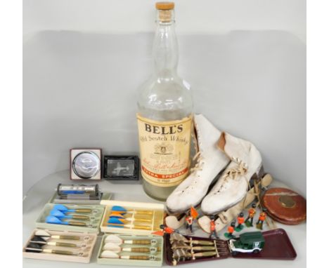 A box of assorted items to include ice skates, small stool, large Bell's scotch whiskey bottle, embroidery magazines, Unicorn