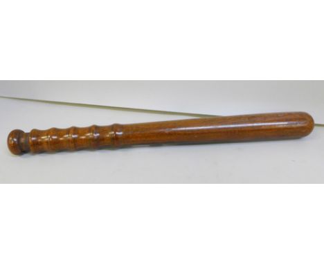 A heavy wooden truncheon marked SC210 