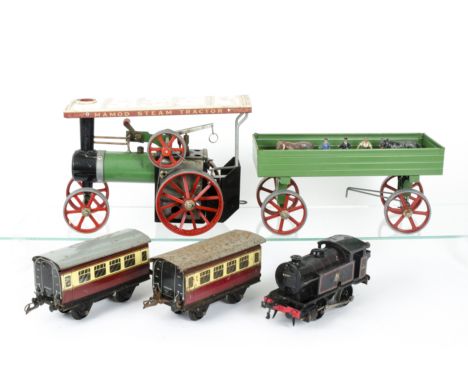 A Mamod TE1A Live Steam Traction Engine with a Hornby O Gauge Clockwork Train and Figures, The TE1A in green/red, with drive 