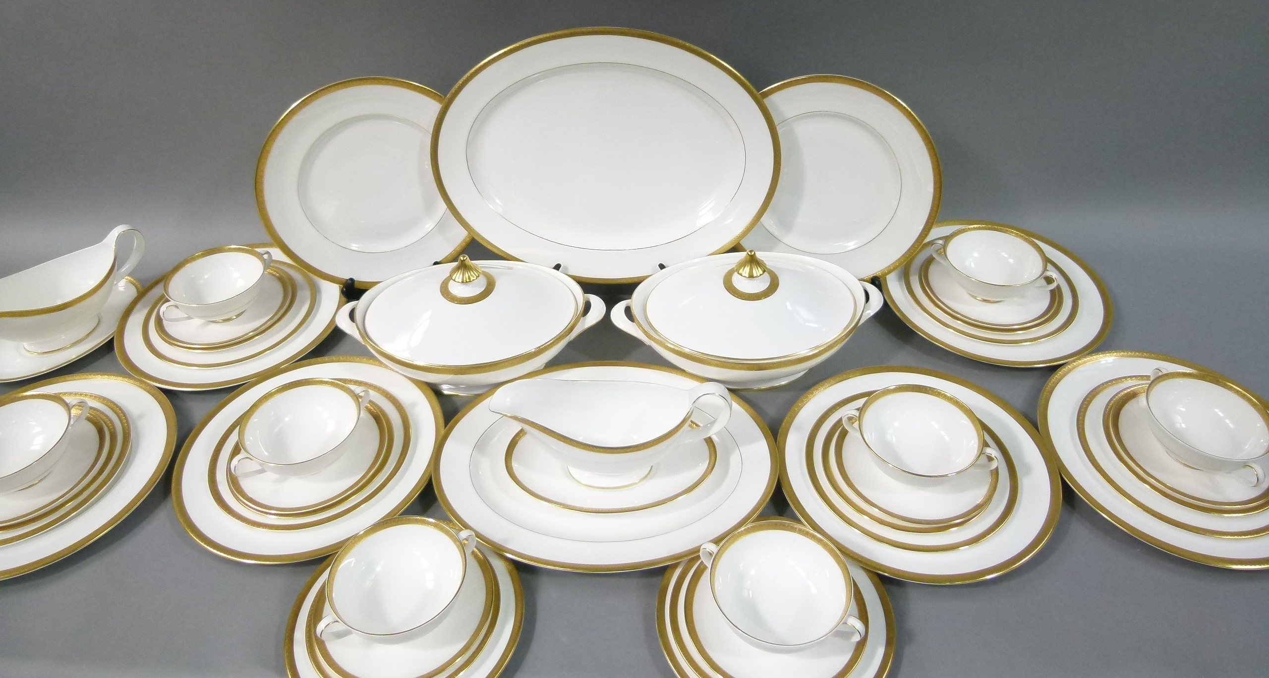 A Royal Doulton dinner service 'Royal Gold' for eight settings