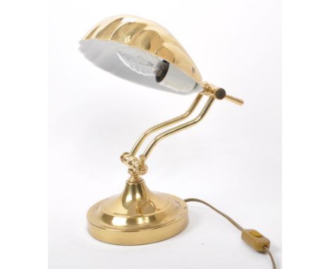 A contemporary late 20th century art deco style brass table lamp. The lamp featuring a scallop / clam shaped shade with an at