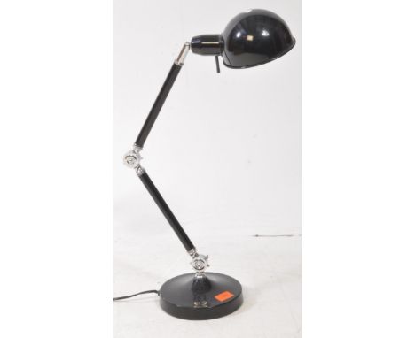 A contemporary modernist anglepoise table / desk lamp. The lamp having domed shade over sprung arm on a weighted circular bas