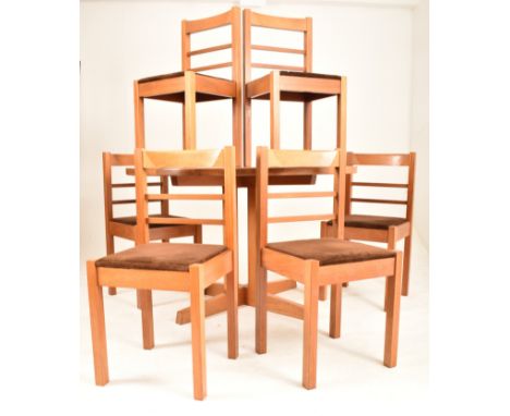 A retro mid 20th century Danish influenced dining table and six matching chairs. The table having a rounded elm top supported