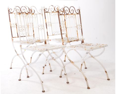 Four vintage 20th-century cast and wrought metal, white painted folding garden chairs. Featuring a metal slatted backrest and