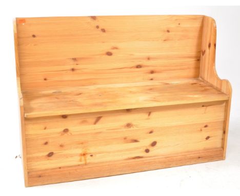 A vintage 20th century pine settle hall bench. The bench having shaped armrests and underseat storage on plinth base.86x122x4