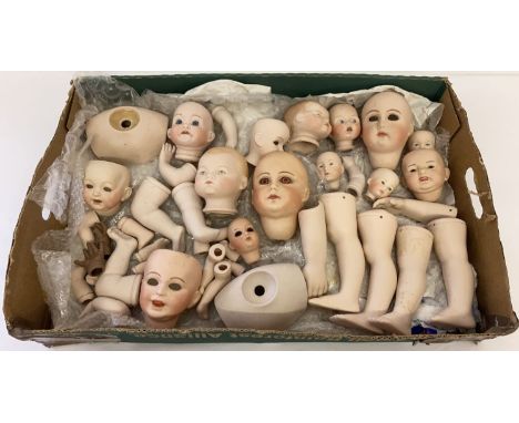 A box of assorted ceramic dolls heads and body parts. To include examples marked Germany and Paris. 