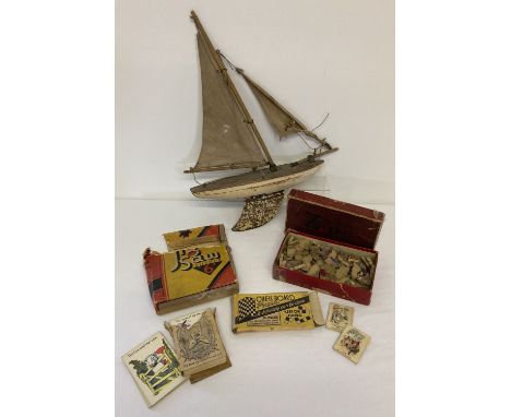 A small collection of assorted vintage toys to include and wooden pond yacht. Lot also includes: Cow &amp; Gate snap game, bo