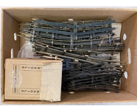 A box of vintage 3 rail O gauge model railway track in varying lengths.  