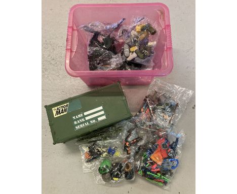 An Action Man green plastic carry crate together with a quantity of assorted Action Man accessories. To include: guns, boots,