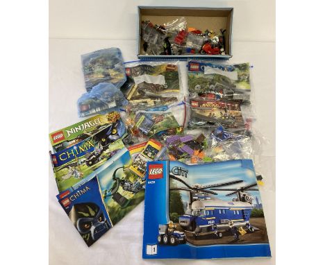 A collection of assorted Lego play pieces and instruction manuals. To include: Chima, Lord of the Rings, Hero Factory and Mar