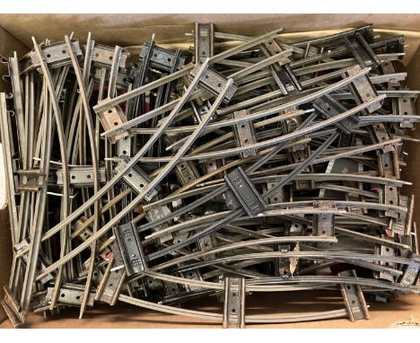 A box of assorted vintage O gauge model railway track and points.  