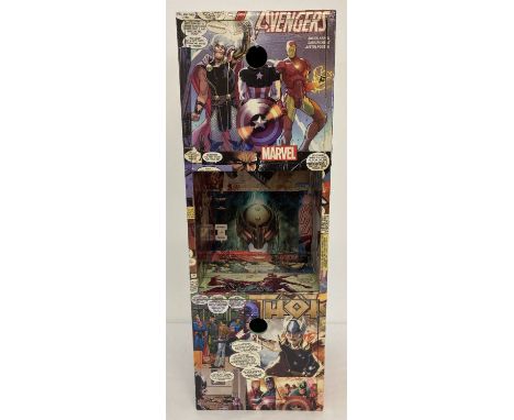 A small modern wooden storage unit with Avengers decoupage decoration. Unit has 2 small drawers and one open shelf, can be us