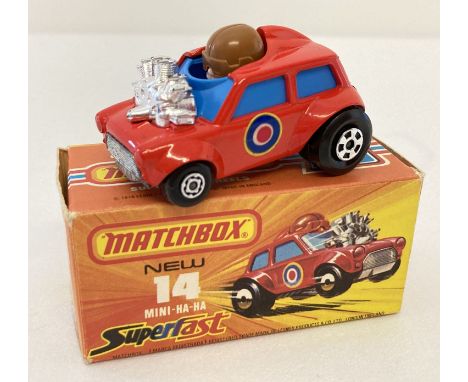 A boxed 1970's Matchbox Superfast diecast car, #14 Mini Ha-Ha. In red and blue with silver trim and bullseye decals to each s